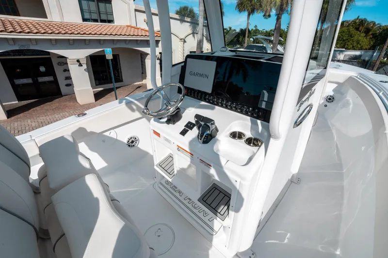 Slide: The Image of 2025 Sea Hunt GAMEFISH 27 CB boat interior with Garmin navigation system and sleek design. - 25