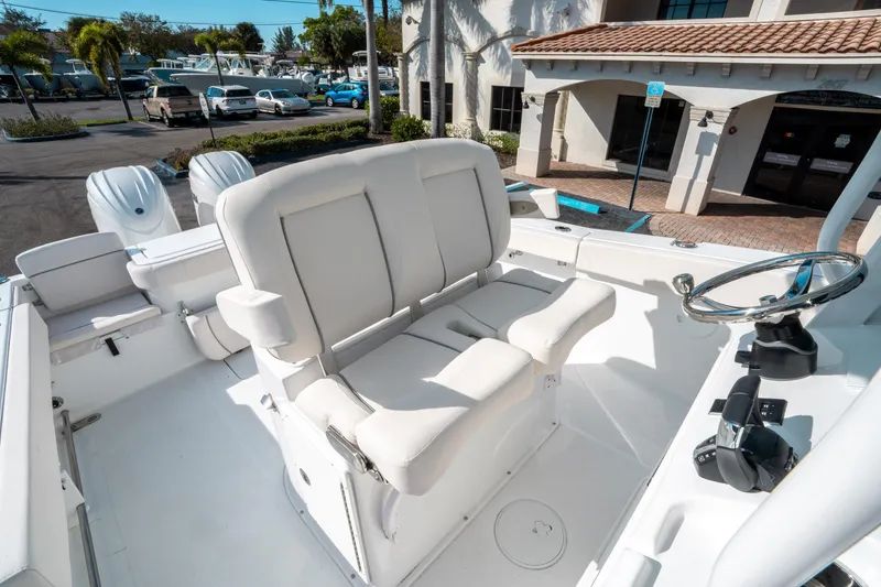 Slide: The Image of 2025 Sea Hunt GAMEFISH 27 CB boat interior with white seating and steering wheel. - 30