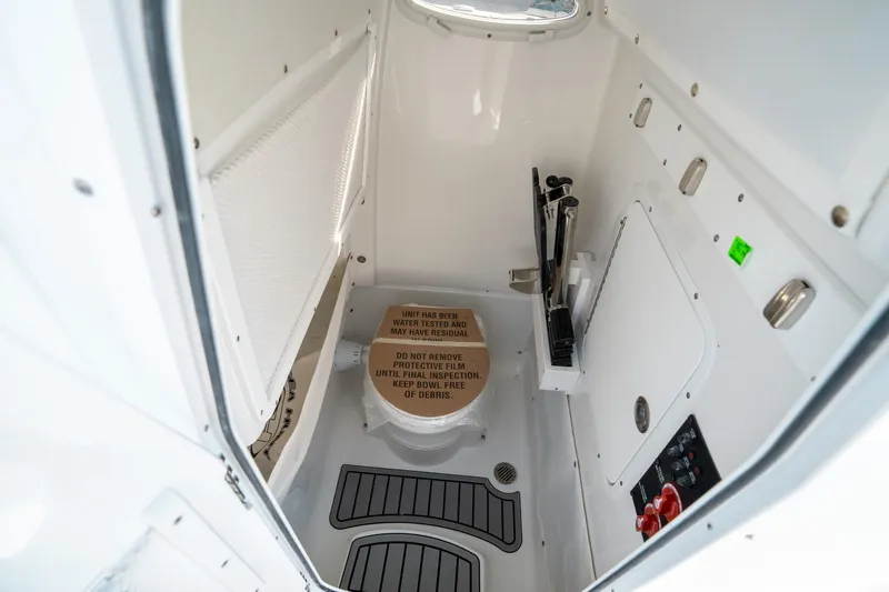 Slide: The Image of 2025 Sea Hunt GAMEFISH 27 CB interior cabin with toilet and storage features. - 32