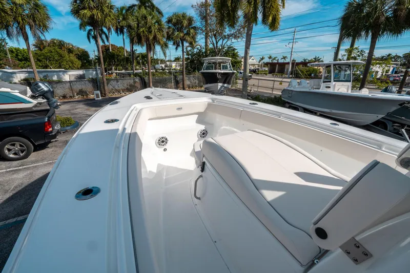 Slide: The Image of 2025 Sea Hunt GAMEFISH 27 CB boat, white interior, palm trees in background. - 33