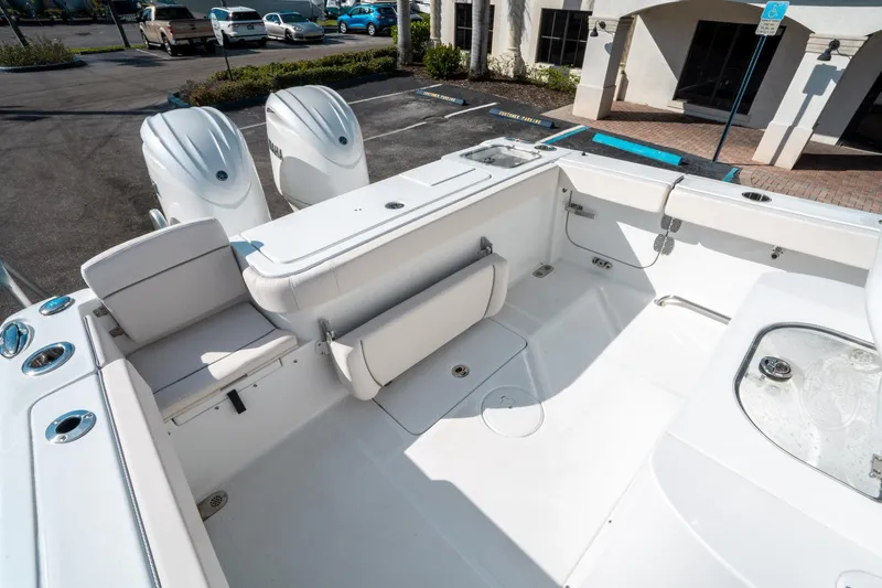 Slide: The Image of 2025 Sea Hunt GAMEFISH 27 CB boat interior with dual engines and seating area. - 12