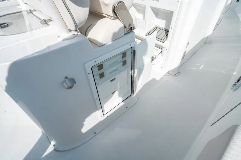 Slide: The Image of 2025 Sea Hunt GAMEFISH 27 CB boat interior with storage compartment and seating. - 18