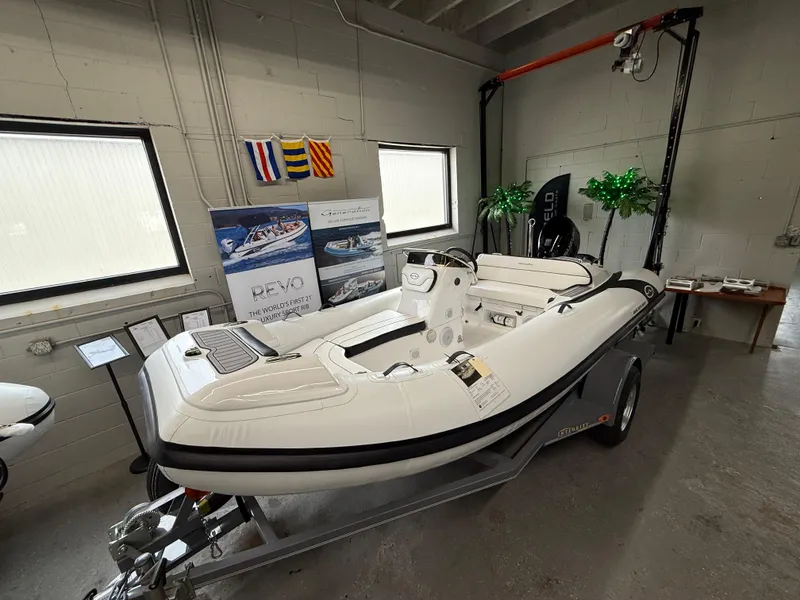 Slide: The Image of 2025 Walker Bay Generation 450 DLX boat displayed indoors on a trailer. - 1