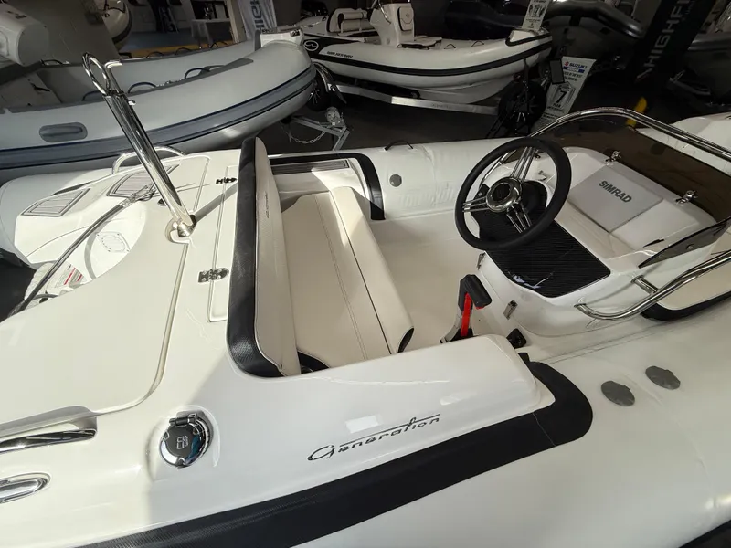 Slide: The Image of 2025 Walker Bay Generation 450 DLX boat interior with steering wheel and seating. - 11