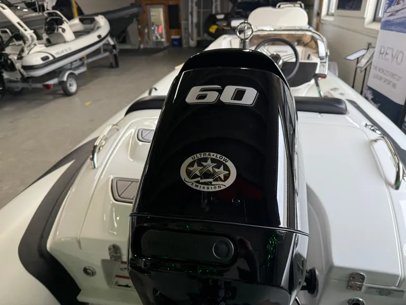 Slide: The Image of 2025 Walker Bay Generation 450 DLX with 60 HP engine in showroom. - 3