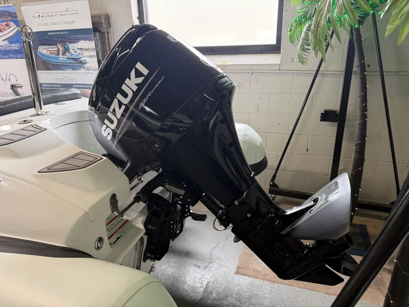 Slide: The Image of 2025 Walker Bay Generation 450 DLX with Suzuki outboard motor in showroom. - 4