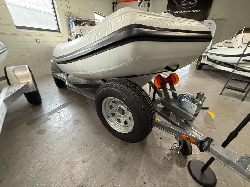 Slide: The Image of 2025 Walker Bay Generation 450 DLX boat on trailer in indoor showroom. - 7