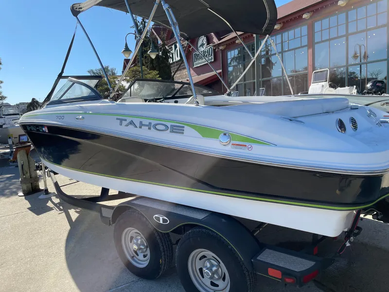 Slide: The Image of 2018 Tahoe 700 Limited boat on trailer, parked outdoors. - 4