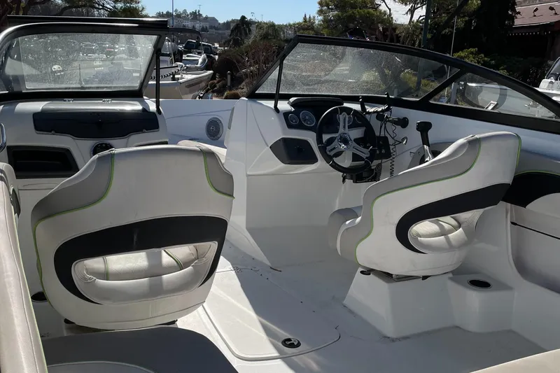 Slide: The Image of 2018 Tahoe 700 Limited boat interior with white seating and steering wheel. - 5