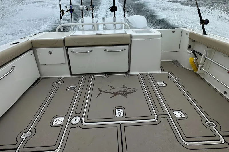 Slide: The Image of 2019 Pursuit OS 355 Offshore boat deck with fishing rod holders and fish design. - 5