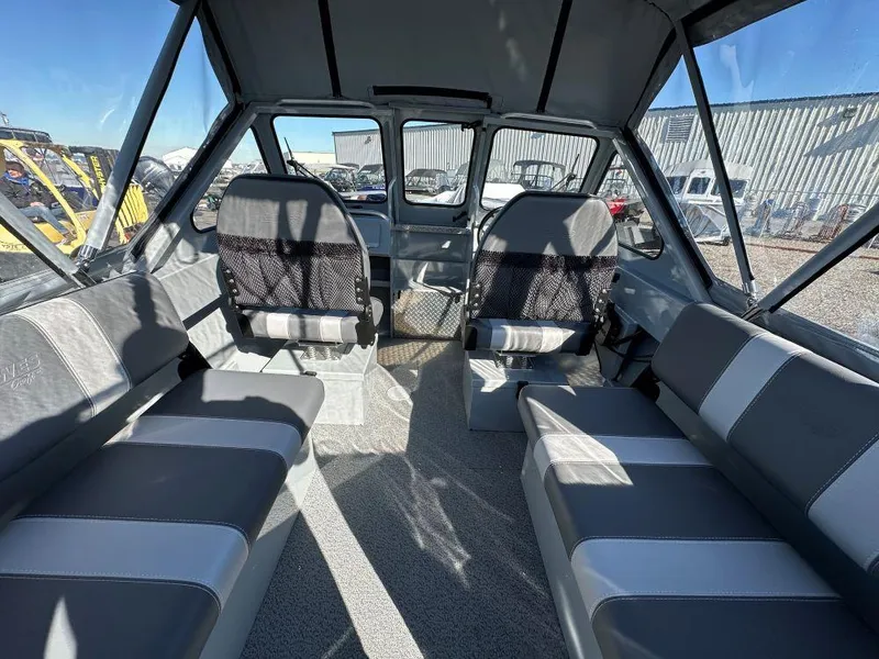 Slide: The Image of Interior of 2025 Hewescraft 180 Sportsman boat with seating and windows. - 6