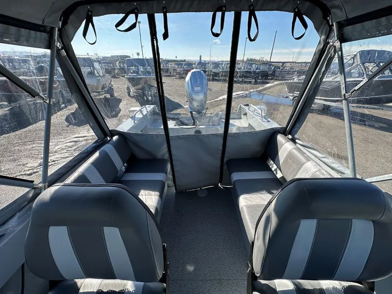 Slide: The Image of 2025 Hewescraft 180 Sportsman boat interior with seating and clear canopy. - 8