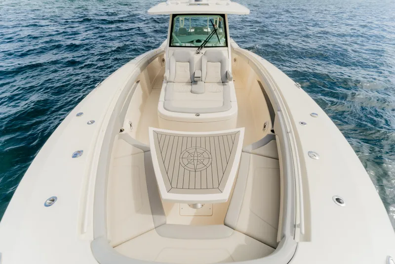 Slide: The Image of 2021 Scout 380 LXF boat on open water, showcasing luxurious seating and sleek design. - 10