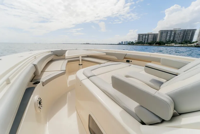 Slide: The Image of 2021 Scout 380 LXF boat interior with luxurious seating, ocean view, and modern design. - 11