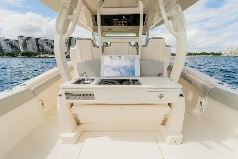 Slide: The Image of 2021 Scout 380 LXF boat interior with seating and amenities on the water. - 12