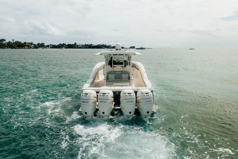 Slide: The Image of 2021 Scout 380 LXF boat cruising on open water with four engines. - 6