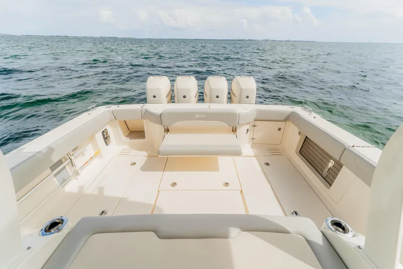 Slide: The Image of 2021 Scout 380 LXF boat deck with quad engines on open sea. - 9