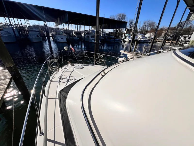 Slide: The Image of 2005 Carver 444 Cockpit Motor Yacht docked in a marina under a clear blue sky. - 10