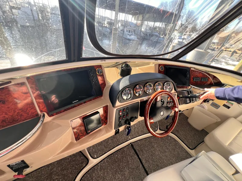 Slide: The Image of Interior cockpit of 2005 Carver 444 Cockpit Motor Yacht with steering wheel and control panels. - 16
