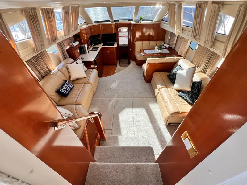 Slide: The Image of Luxurious interior of 2005 Carver 444 Cockpit Motor Yacht with leather seating and wood finishes. - 18