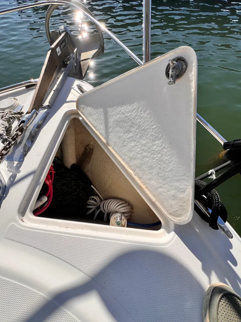 Slide: The Image of Open storage compartment on 2005 Carver 444 Cockpit Motor Yacht, with ropes and anchor visible. - 20