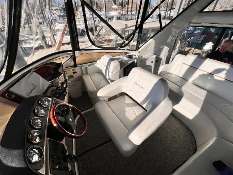 Slide: The Image of Interior of 2005 Carver 444 Cockpit Motor Yacht with white seating and control panel. - 22