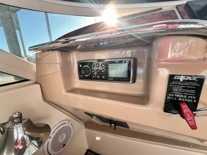 Slide: The Image of 2005 Carver 444 Cockpit Motor Yacht dashboard with stereo and fire extinguisher controls. - 26