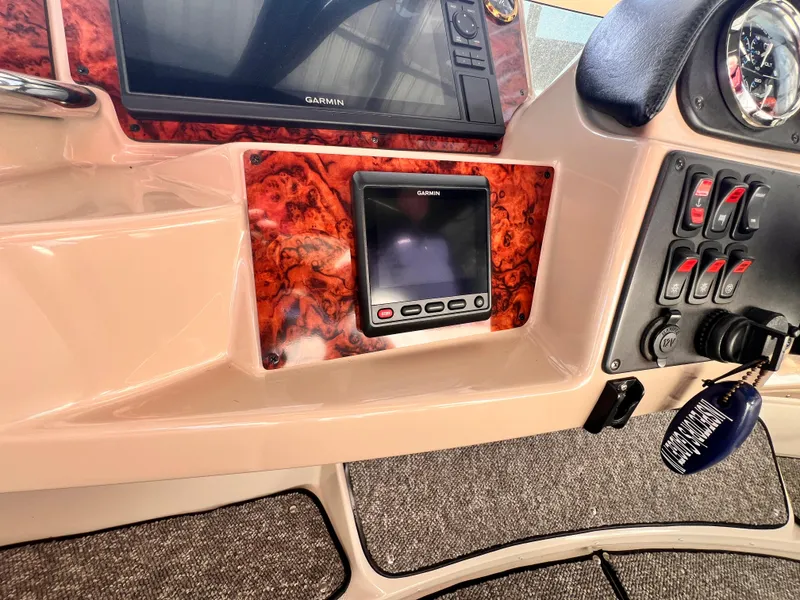 Slide: The Image of Control panel of 2005 Carver 444 Cockpit Motor Yacht with Garmin display and switches. - 27