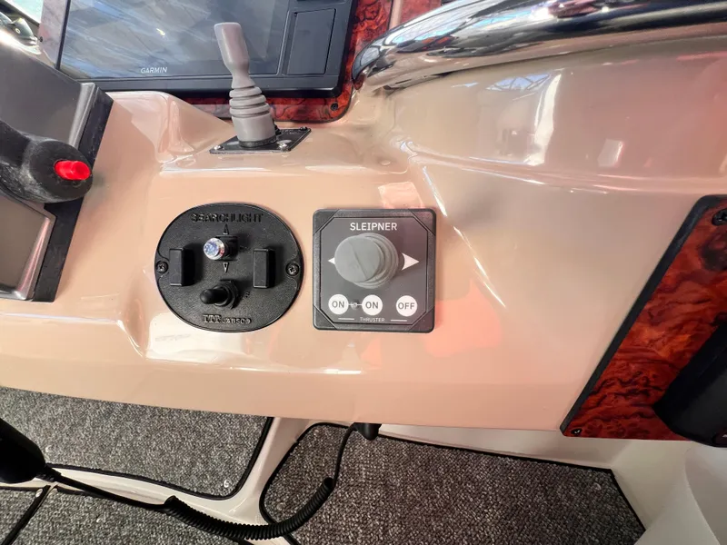 Slide: The Image of Control panel of a 2005 Carver 444 Cockpit Motor Yacht with searchlight and Sleipner thruster controls. - 28