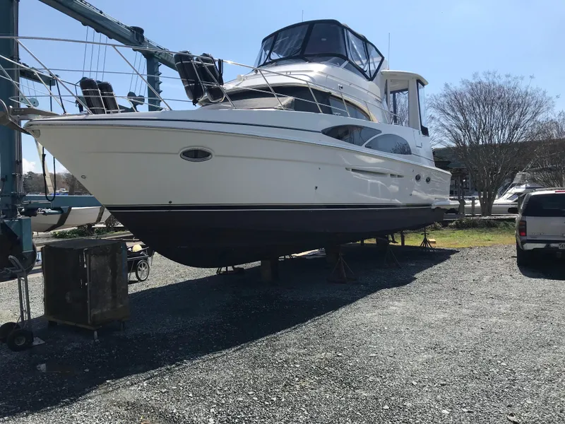 Slide: The Image of 2005 Carver 444 Cockpit Motor Yacht on dry dock, side view. - 3