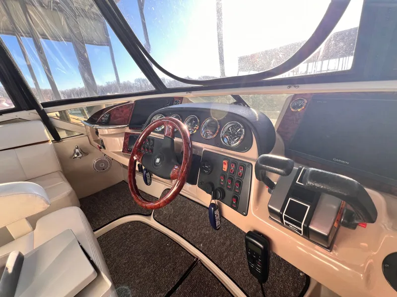 Slide: The Image of 2005 Carver 444 Cockpit Motor Yacht helm with steering wheel and control panel. - 30