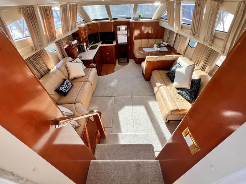 Slide: The Image of Luxurious interior of 2005 Carver 444 Cockpit Motor Yacht with plush seating and elegant wood finishes. - 32
