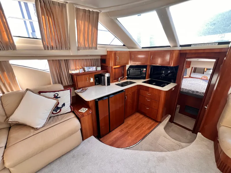 Slide: The Image of Luxurious interior of 2005 Carver 444 Cockpit Motor Yacht with modern kitchen and cozy seating. - 35