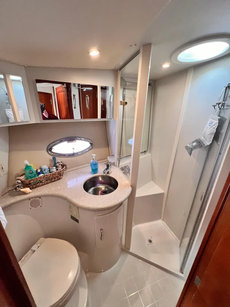 Slide: The Image of Bathroom interior of 2005 Carver 444 Cockpit Motor Yacht, featuring sink, toilet, and shower. - 38