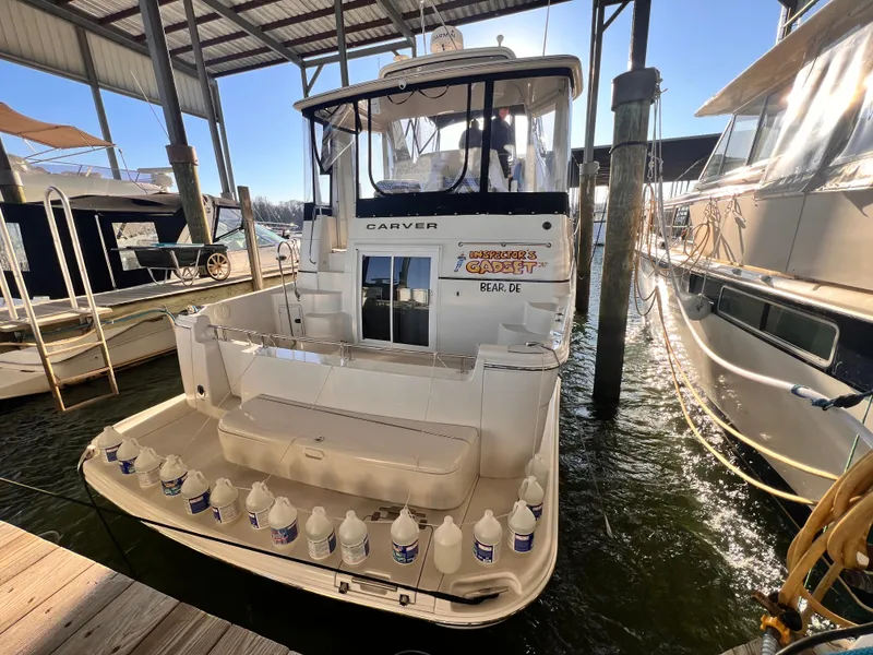 Slide: The Image of 2005 Carver 444 Cockpit Motor Yacht docked in marina, rear view. - 4