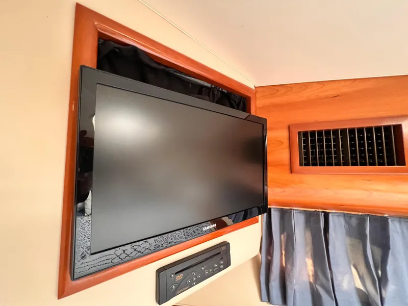 Slide: The Image of Flat-screen TV and DVD player in 2005 Carver 444 Cockpit Motor Yacht interior. - 42