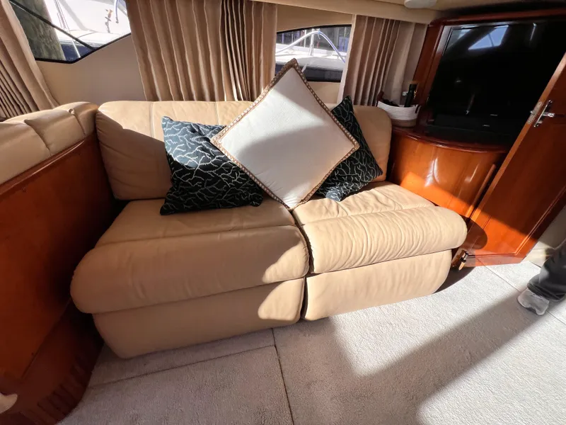 Slide: The Image of Interior of 2005 Carver 444 Cockpit Motor Yacht with beige sofa and decorative pillows. - 48