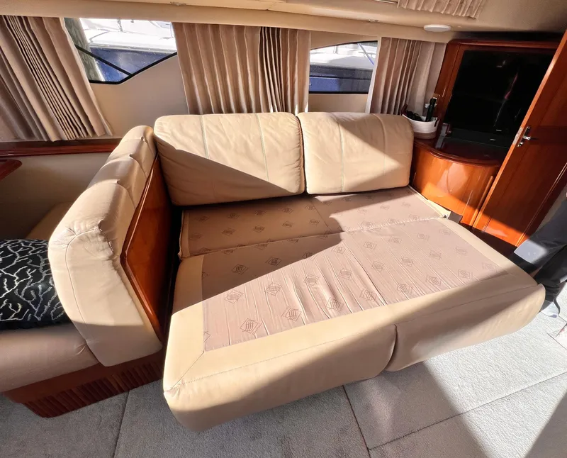 Slide: The Image of Interior of 2005 Carver 444 Cockpit Motor Yacht with beige leather seating. - 49