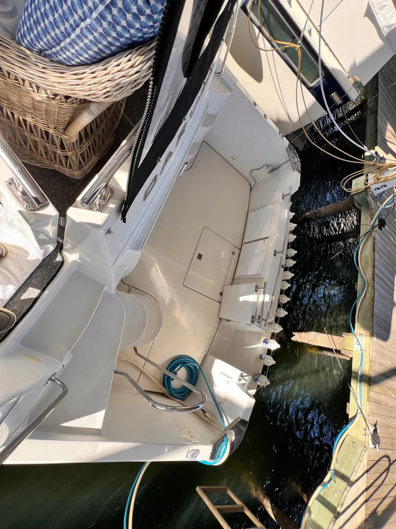 Slide: The Image of 2005 Carver 444 Cockpit Motor Yacht docked, showing spacious deck and water view. - 5