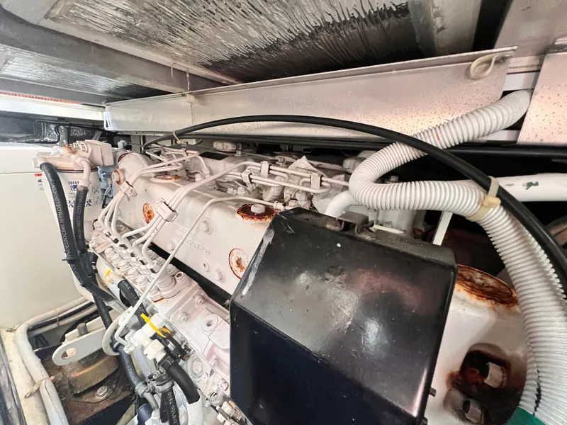 Slide: The Image of Engine compartment of a 2005 Carver 444 Cockpit Motor Yacht, showing detailed machinery. - 51