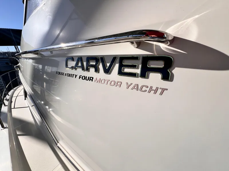 Slide: The Image of 2005 Carver 444 Cockpit Motor Yacht side view with logo and chrome details. - 7