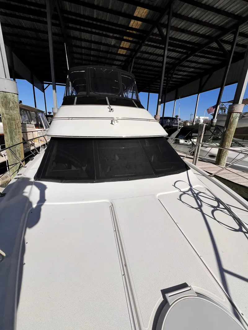 Slide: The Image of 2005 Carver 444 Cockpit Motor Yacht docked under a covered marina. - 8