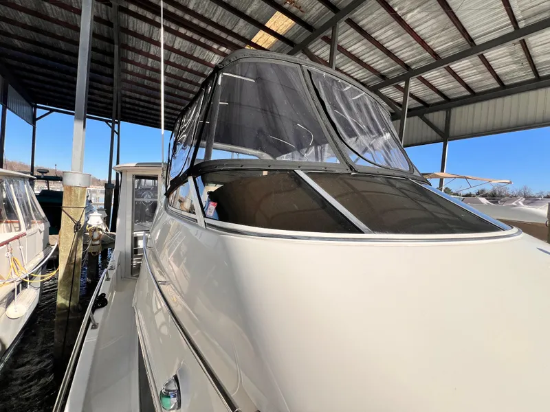 Slide: The Image of 2005 Carver 444 Cockpit Motor Yacht docked under a covered marina. - 9