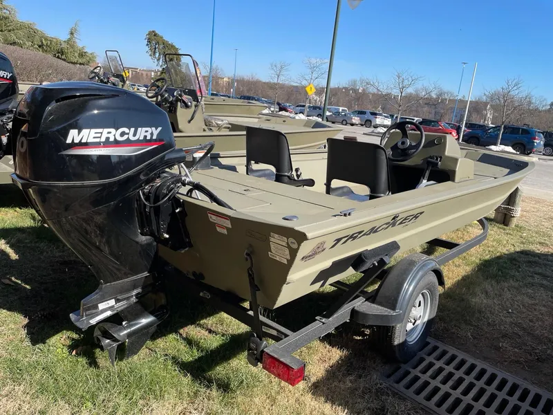 Slide: The Image of 2023 Tracker Grizzly 1754 boat with Mercury engine on trailer, parked outdoors. - 3