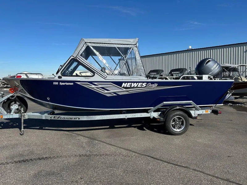 The Image of 2025 Hewescraft 200 Sportsman boat on trailer, blue exterior, parked outdoors. - 0