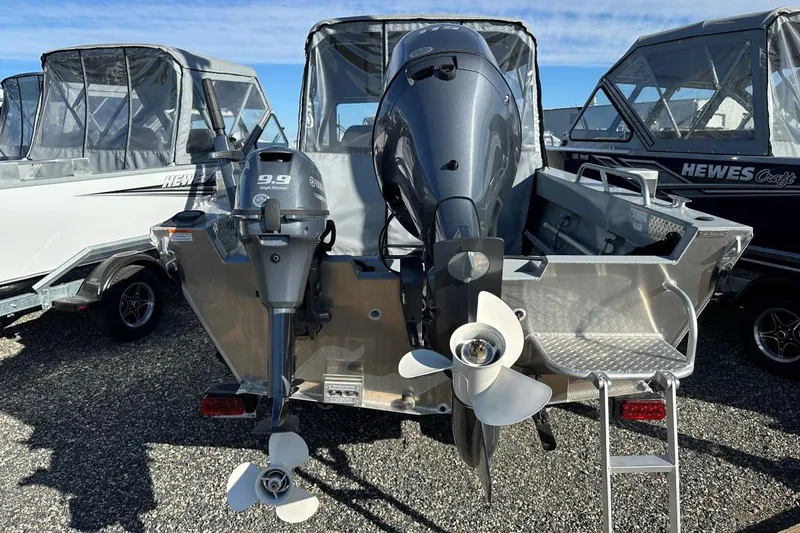 Slide: The Image of 2025 Hewescraft 200 Sportsman boat with dual outboard motors, displayed outdoors. - 9