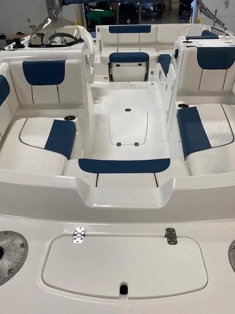 Slide: The Image of 2022 Tahoe 1950 boat interior with blue and white seating arrangement. - 2