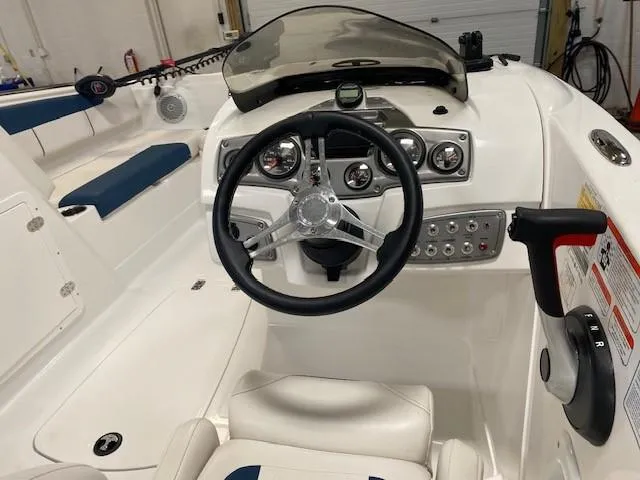 Slide: The Image of Interior of a 2022 Tahoe 1950 boat, featuring steering wheel and control panel. - 3