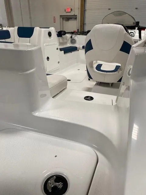 Slide: The Image of Interior of a 2022 Tahoe 1950 boat, featuring white and blue seating. - 4