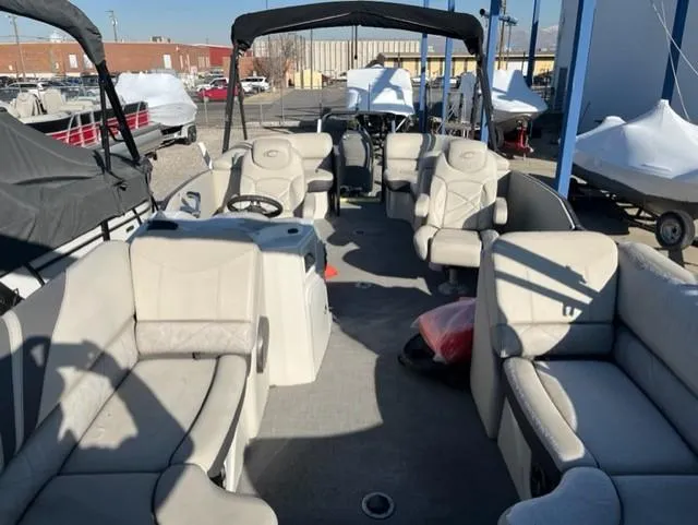 Slide: The Image of 2019 Crest 230 SLC pontoon boat with spacious seating, docked in a marina. - 3